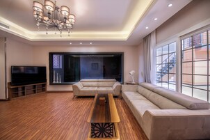 Royal Villa | Living area | 50-inch TV with satellite channels