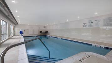 Relax by the pool surrounded by a spacious deck and comfortable seating.