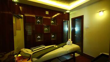 Experience rejuvenation in this serene space, featuring a massage table and a cabinet for spa essentials.
