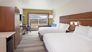 A hotel room with two beds, a desk, a chair, and a view of mountains. - Holiday Inn Express & Suites Brigham City - North Utah by IHG (Brigham City)