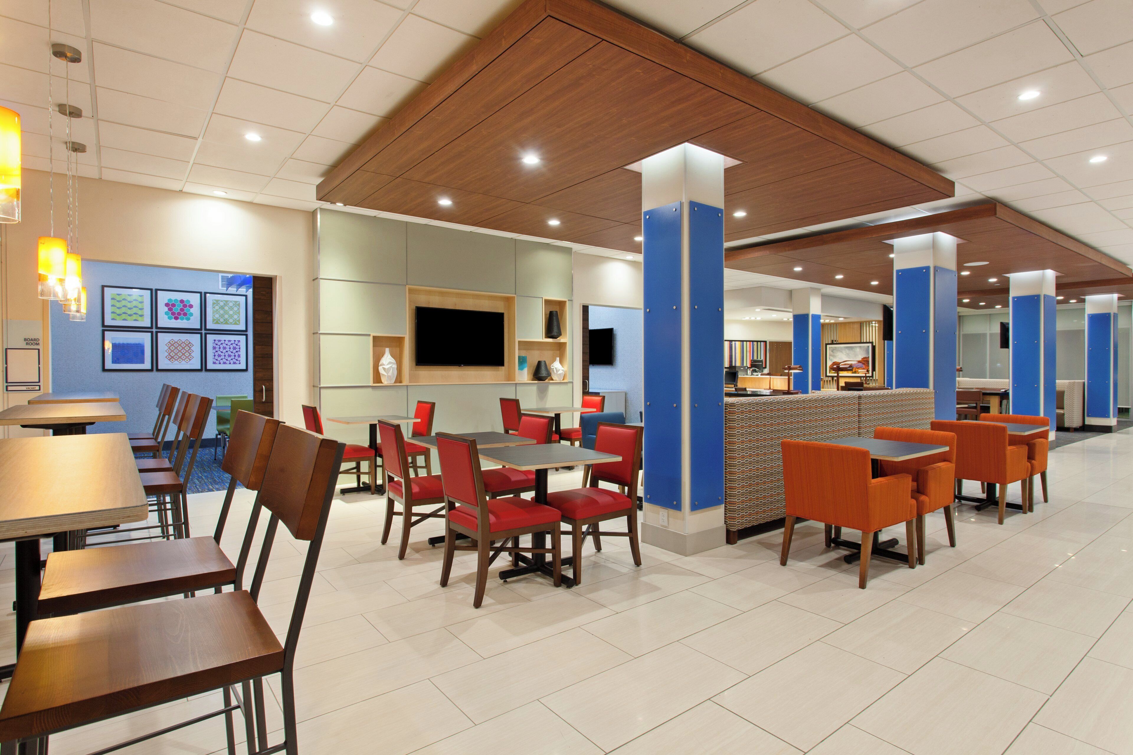 A restaurant with multiple dining areas, including booths and tables with chairs.