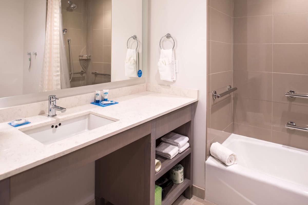 hydromassage showerhead, designer toiletries, hair dryer, towels