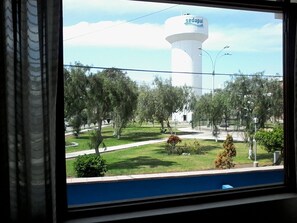 A view of a water tower labeled 'sedapal' with a green park area in the foreground. - Royal Sweet Dreams Airport B&B (Lima)