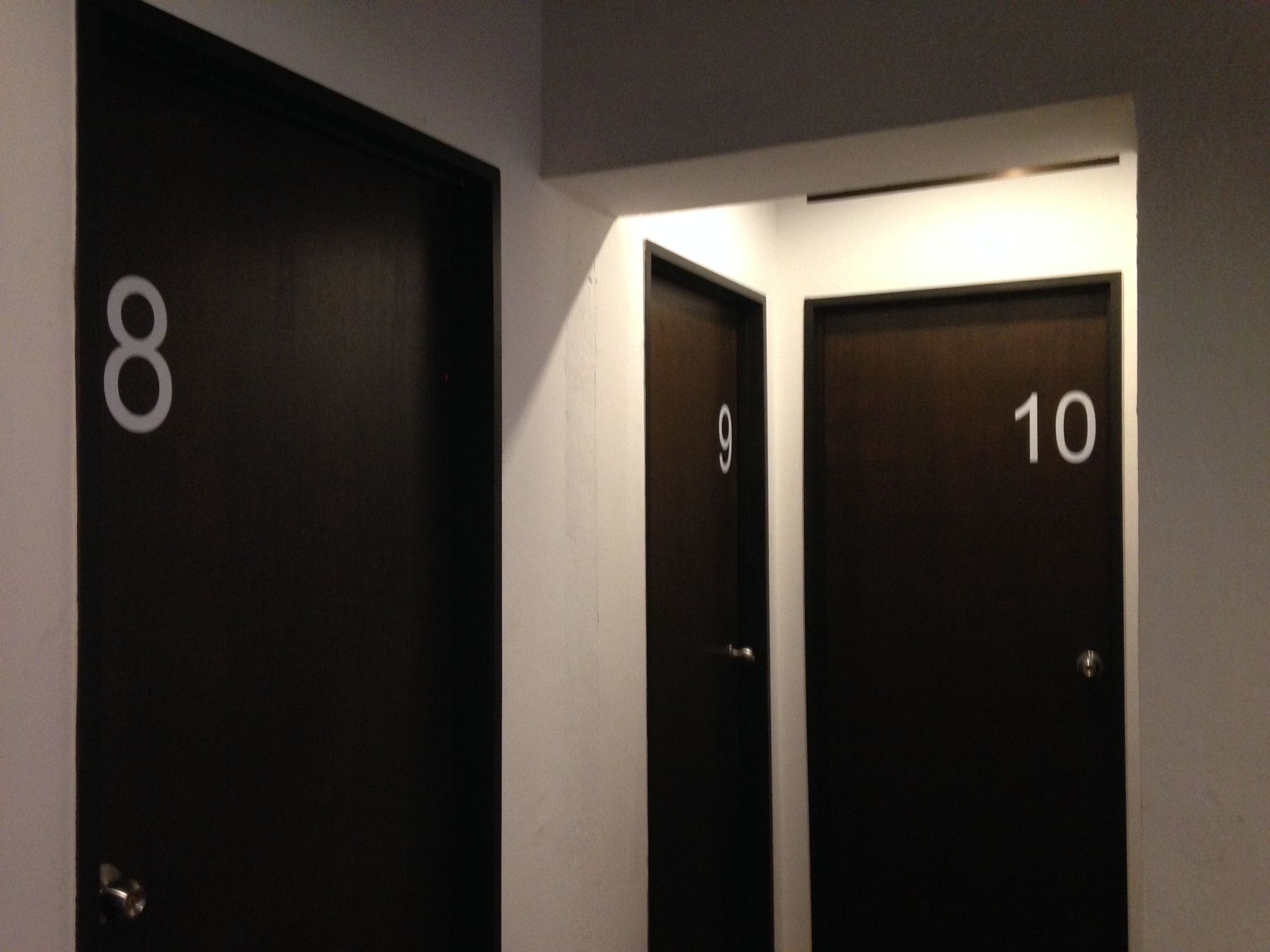 A hallway with doors numbered 8, 9, and 10.