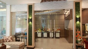 A modern interior with a dining area, kitchen, and seating space. - Levana Pattaya Hotel (Pattaya)