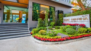 A modern building with a sign reading "SUN MARINA".