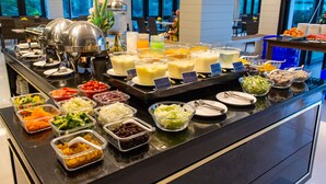 A buffet with various food items and beverages.