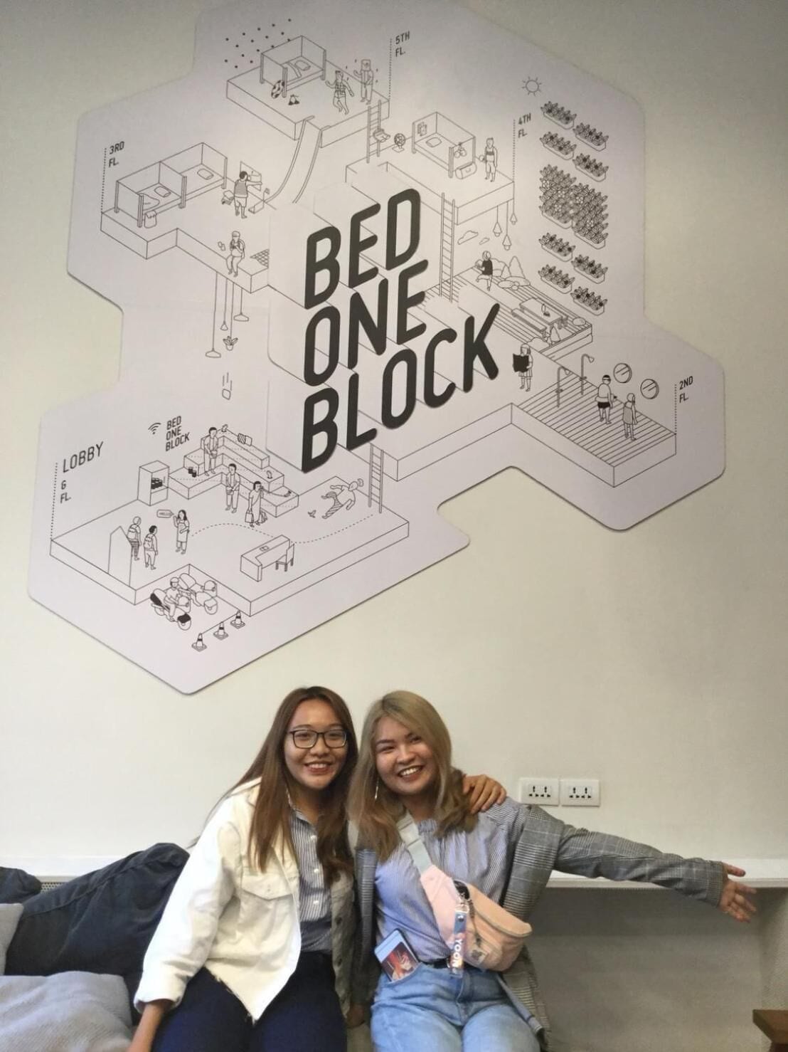 A wall with a Bed One Block illustration, including a lobby, bedrooms, and a bathroom.