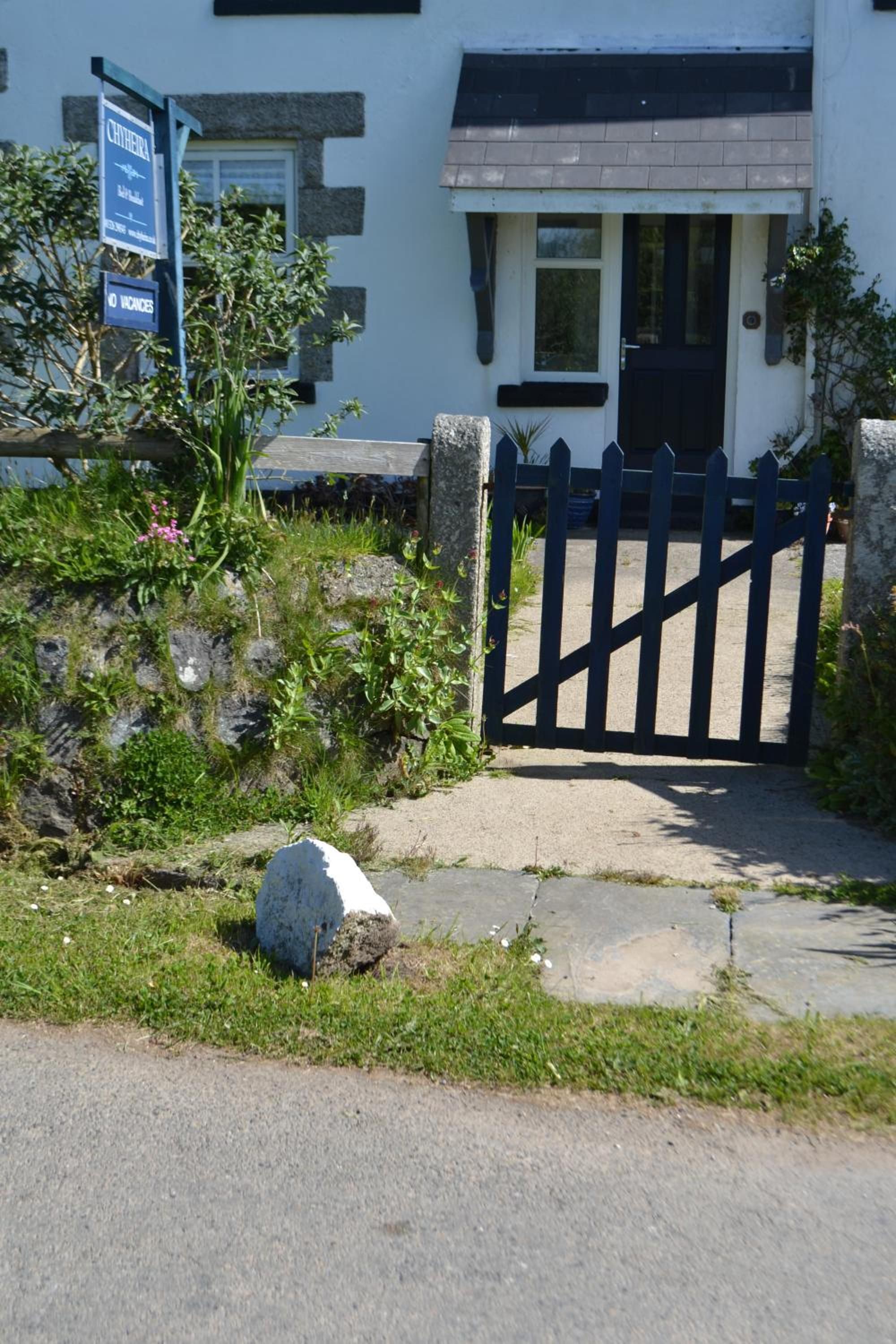 A gated entrance to a building with a sign indicating no vacancies.