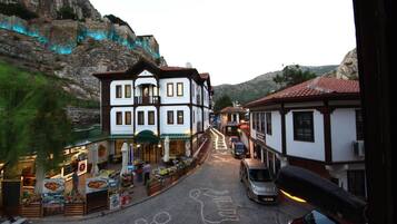 A street with buildings, a café, and a car.