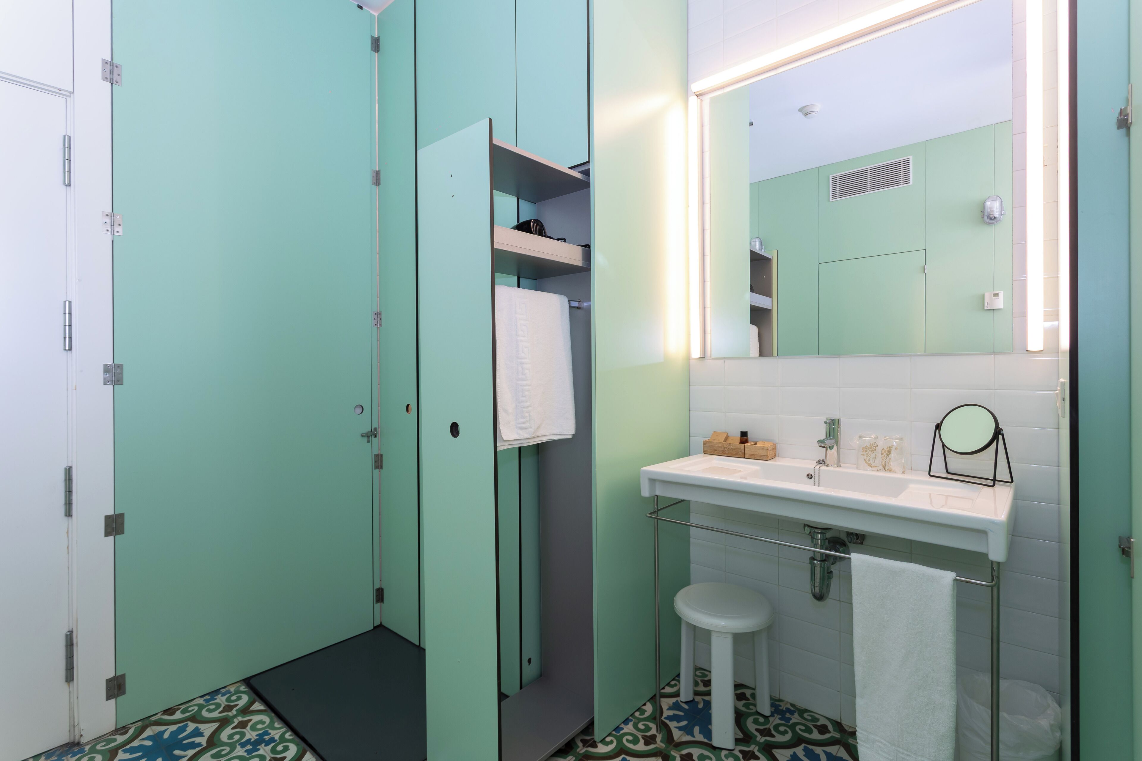 A bathroom with a sink, mirror, and a toilet.