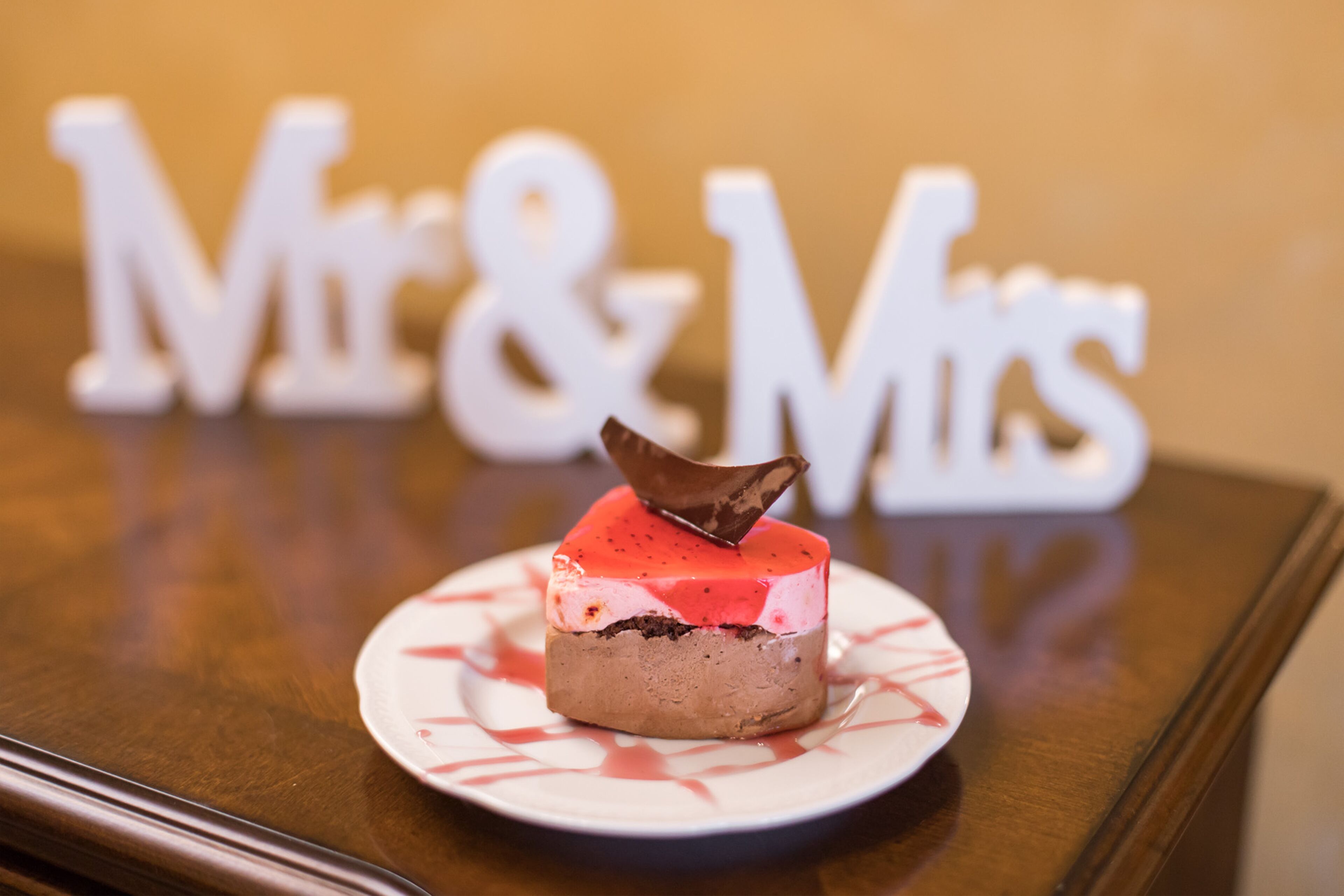 A dessert on a plate with 'Mr & Mrs' letters in the background.