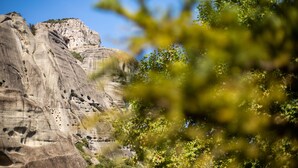 A large rock formation with a clear sky.
