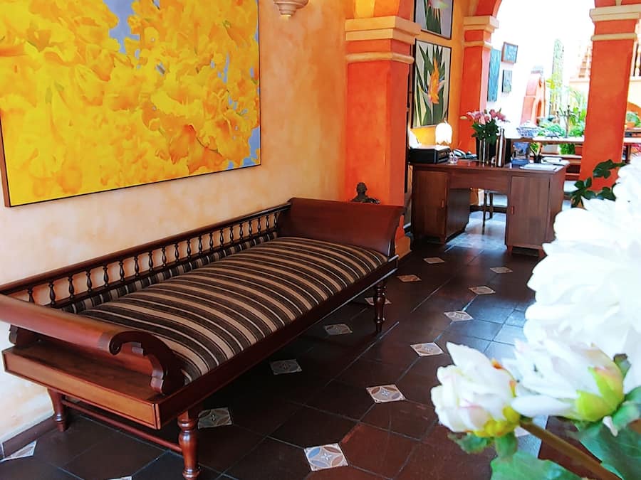 Una habitación con una cama, un mapa en la pared y suelo de baldosas.