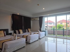 A hotel room with two beds, a large window, and a view of the outside. - Retreat Resort Pattaya (Pattaya)