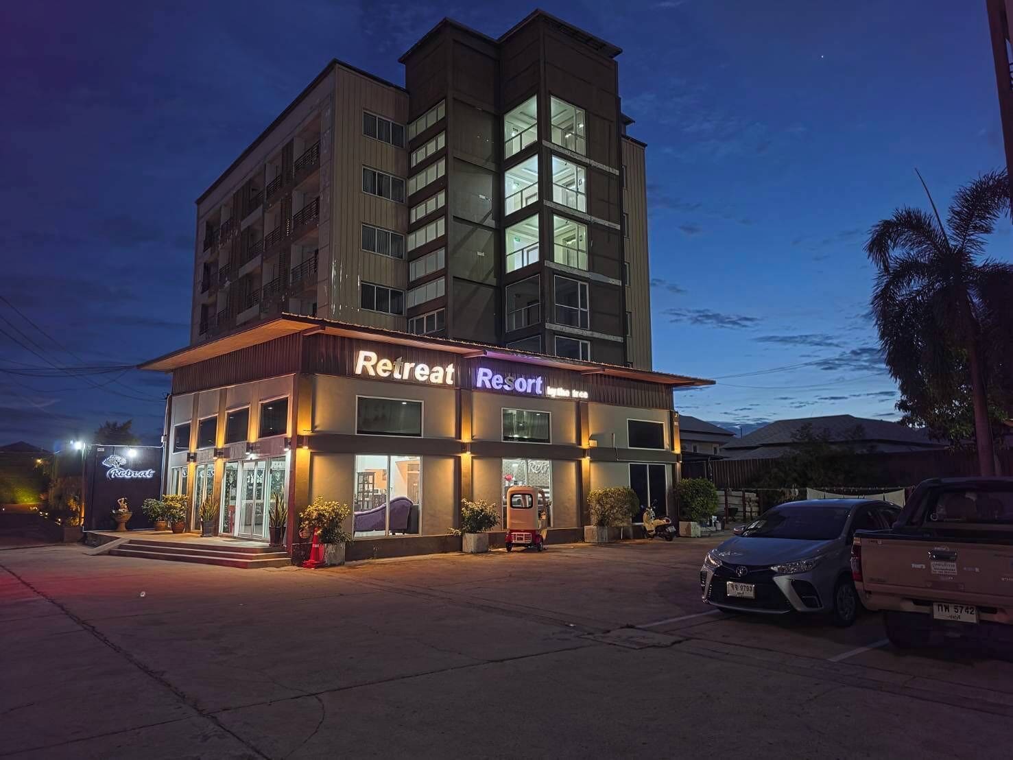 A multi-story building with a sign reading 'Retreat Resort.'