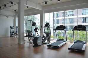 A gym with treadmills, elliptical machines, and weight equipment. - Retreat Resort Pattaya (Pattaya)