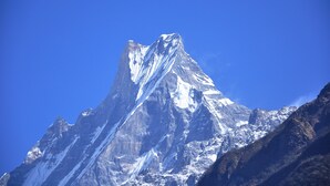 A snow-covered mountain peak with a clear blue sky. - Hotel Bishram (Pokhara)