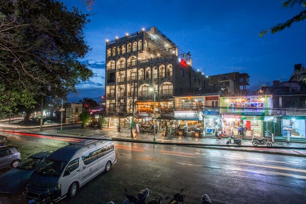 A multi-story building with a traditional architectural style, featuring balconies and large windows. - Hotel Raniban Arcade (Pokhara)