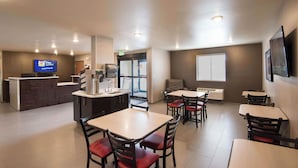 A hotel lobby with a reception desk, a television, and several tables and chairs. - My Place Hotel-Salt Lake City/West Jordan, UT (West Jordan)