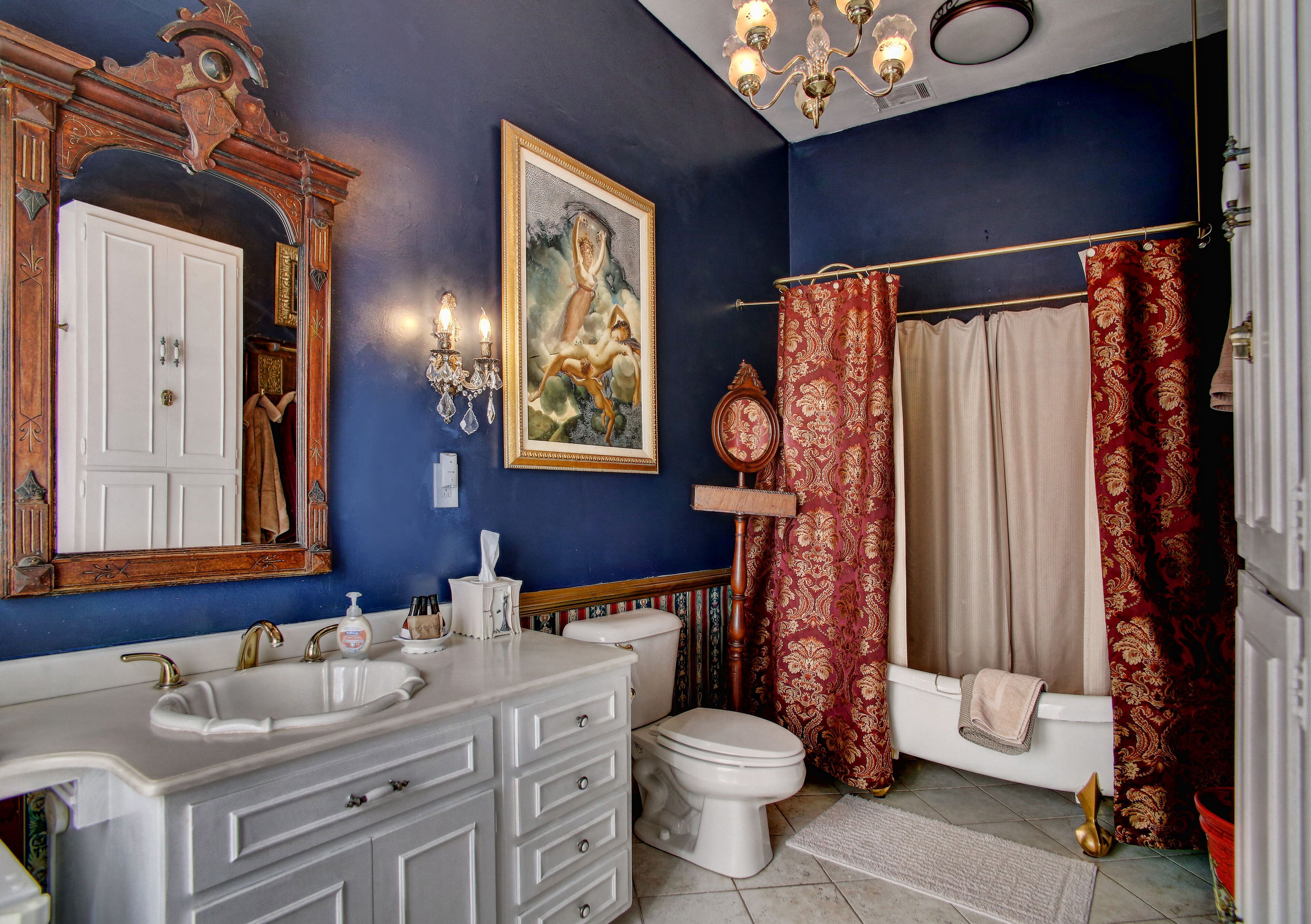 A bathroom with a double sink, a toilet, and a bathtub.