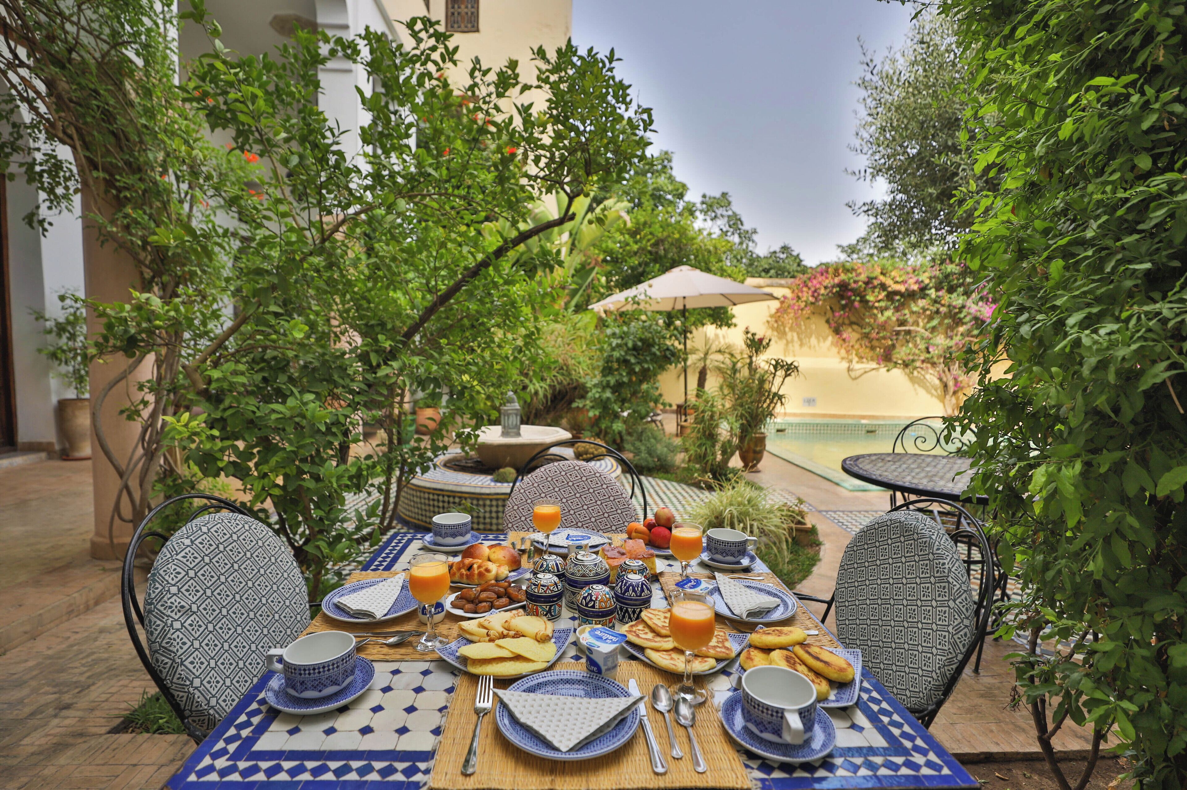 A table set for breakfast with various dishes, drinks, and traditional tableware.