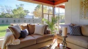 A living room with two sofas, a coffee table, and a large window providing a view of the outdoors. - PX001 3 Bedroom Apartment By Senstay (Phoenix)