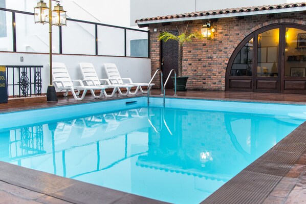Seasonal outdoor pool, pool umbrellas, pool loungers