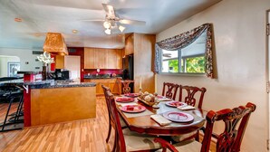 A dining area with a wooden table set for four, surrounded by chairs. - PX008 4 Bedroom Apartment By Senstay (Scottsdale)