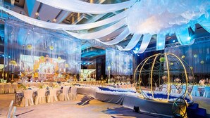 A banquet hall with a stage, white drapery, and a large spherical structure. - Golden Eagle Summit Hotel Nanjing China (Nanjing)