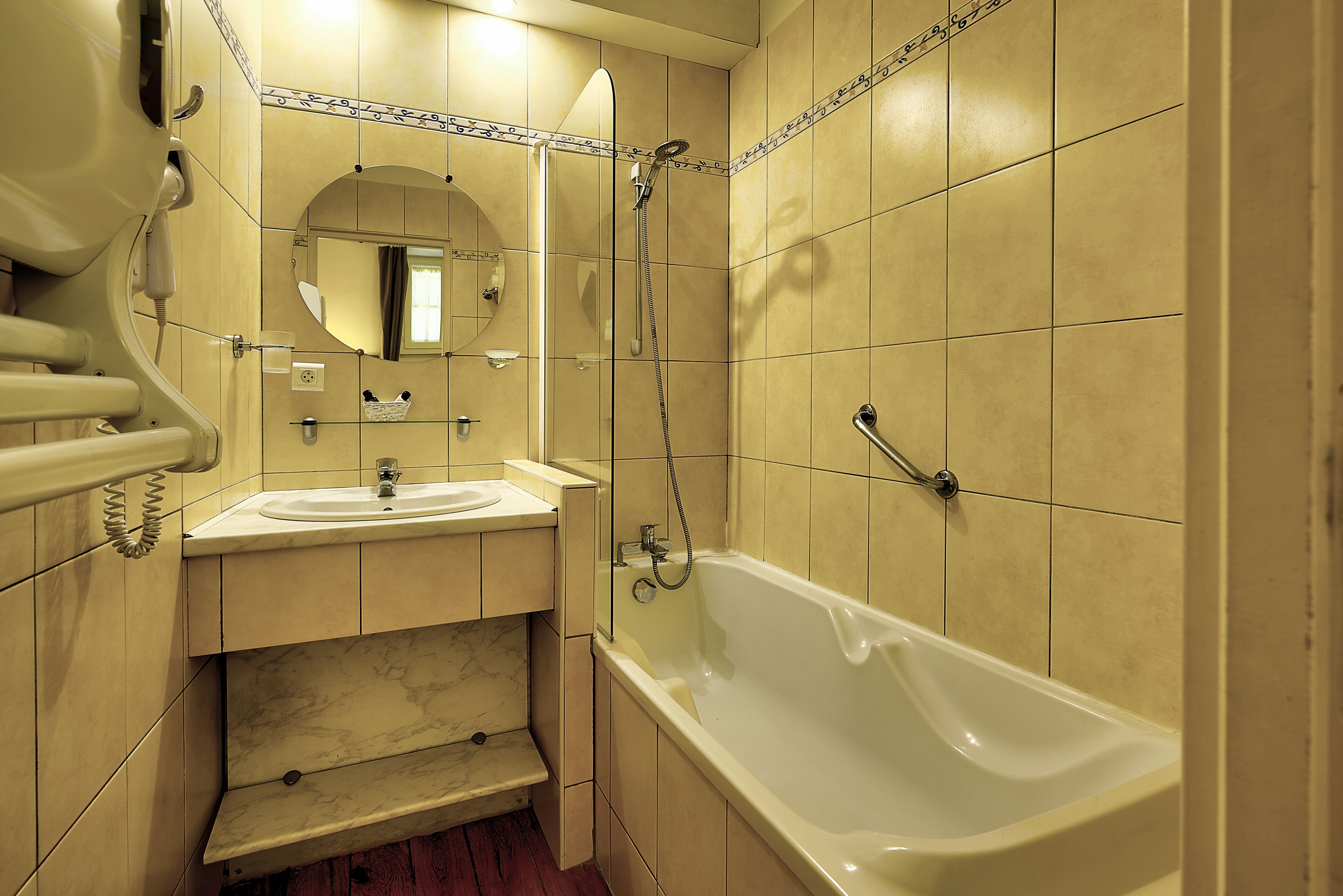 A bathroom with a bathtub, a sink, and a mirror.