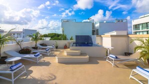 A rooftop terrace with lounge chairs, a hot tub, and a pool. - PDC003 2 Bedroom Apartment By Senstay (Playa del Carmen)
