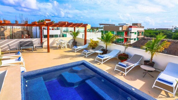 A rooftop pool area with lounge chairs, a small pool, and a pergola. - PDC003 2 Bedroom Apartment By Senstay (Playa del Carmen)