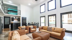 A spacious living area with wicker furniture, a dining area, and a kitchen. - PDC004 7 Bedroom Villa By Senstay (Playa del Carmen)