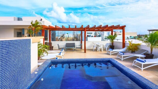 A rooftop pool area with a pergola, lounge chairs, and a dining set. - PDC004 7 Bedroom Villa By Senstay (Playa del Carmen)