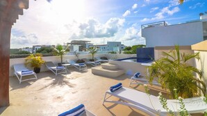 A rooftop terrace with lounge chairs, a hot tub, and potted plants. - PDC004 7 Bedroom Villa By Senstay (Playa del Carmen)