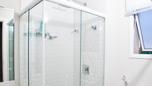 A modern bathroom with a glass-enclosed shower, a white toilet, and a sink with a mirror above it. - FL002 2 Bedroom Apartment By Senstay (Florianópolis)