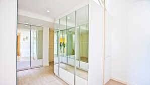 A modern interior with glass partitions, wooden flooring, and recessed lighting. - FL014 3 Bedroom Apartment By Senstay (Florianópolis)
