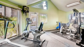 A gym with exercise equipment, large windows, and a view of the outside. - PX033 1 Bedroom Apartment By Senstay (Phoenix)