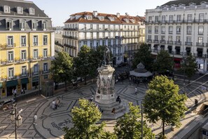 A plaza with a central monument surrounded by buildings.