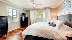 A bedroom with a bed, a dresser, a TV, and a ceiling fan. - PX037 3 Bedroom Apartment By Senstay (Phoenix)