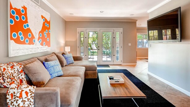 A modern living room with a sectional sofa, a coffee table, and a large abstract painting on the wall. - PX037 3 Bedroom Apartment By Senstay (Phoenix)