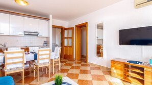 A modern apartment with a kitchen, dining area, and living room. - Apartment in Croatia near Sea Beach & Pool (Crikvenica)