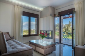 Villa, 3 Bedrooms, Private Pool (Anthelia) | Living area | 43-inch flat-screen TV with satellite channels, plasma TV, fireplace - Olive Garden Villas (Mylopotamos)