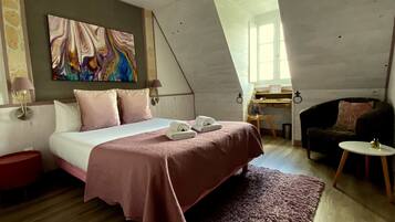 Een slaapkamer met een bed, een bureau en een stoel.