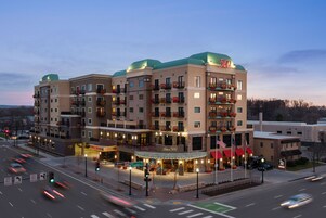 A multi-story hotel with a green roof, balconies with flower boxes, and a sign reading "500".