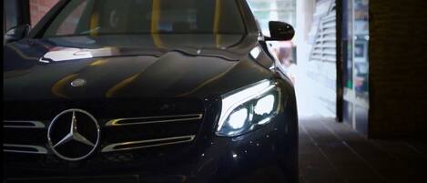 A black Mercedes-Benz car with the text "NOORJAHAN GRAND" on the front.