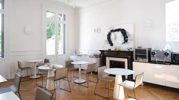 Una cocina moderna con armarios blancos, una isla central y un amplio ventanal.