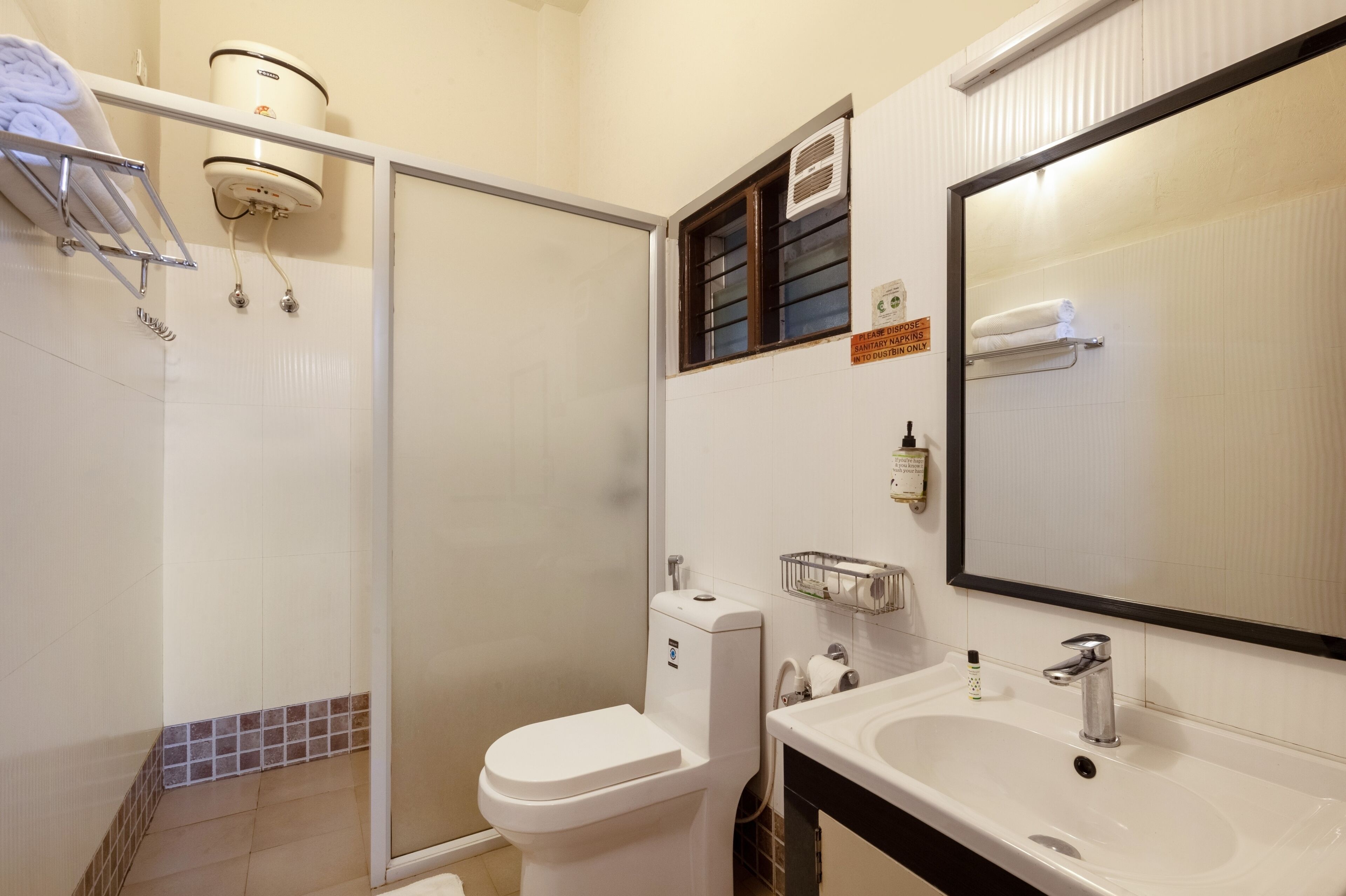 A modern bathroom with a toilet, sink, and shower.