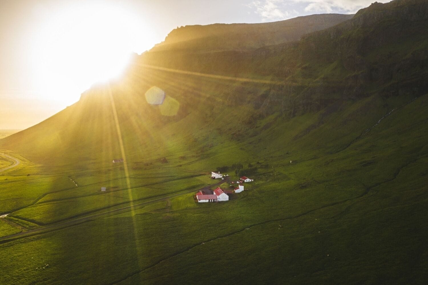 A rural landscape with a house and fields.